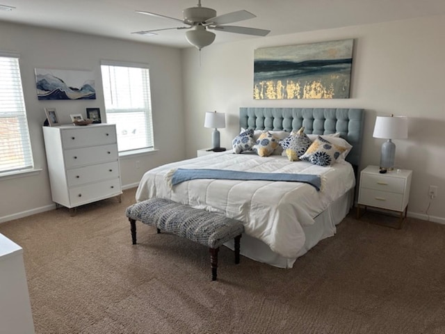 bedroom with baseboards, multiple windows, and carpet flooring