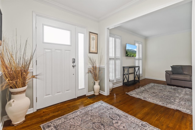 foyer featuring crown molding, wood finished floors, and baseboards