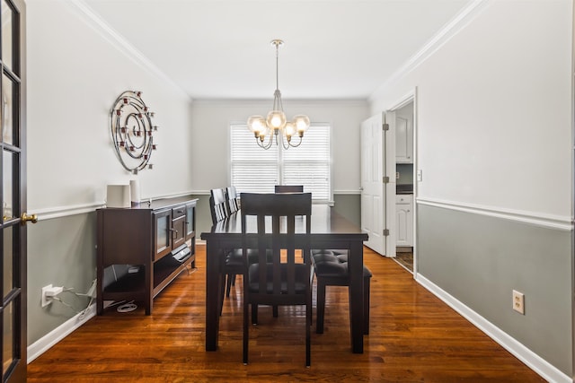 dining area with an inviting chandelier, dark wood finished floors, and ornamental molding