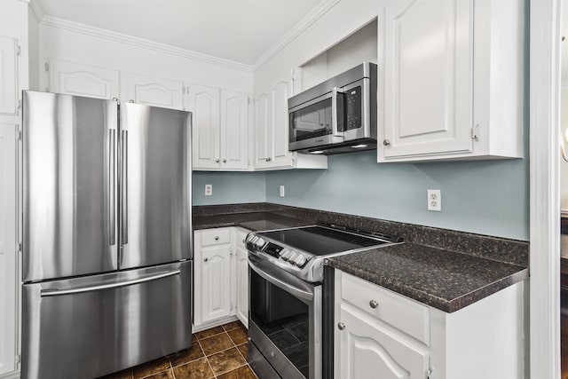 kitchen with white cabinetry, dark countertops, appliances with stainless steel finishes, and ornamental molding