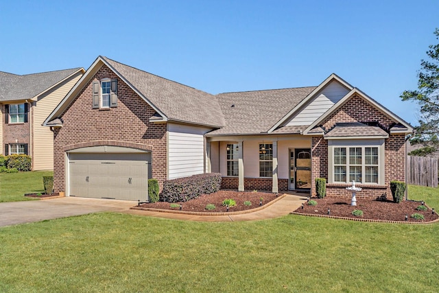 view of front facade with brick siding, concrete driveway, a front yard, and fence