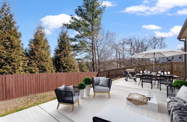 view of patio with outdoor dining space, an outdoor hangout area, and a fenced backyard