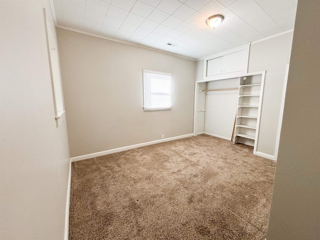 unfurnished bedroom featuring baseboards, carpet floors, and crown molding