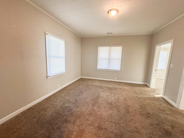 empty room featuring carpet, baseboards, and ornamental molding