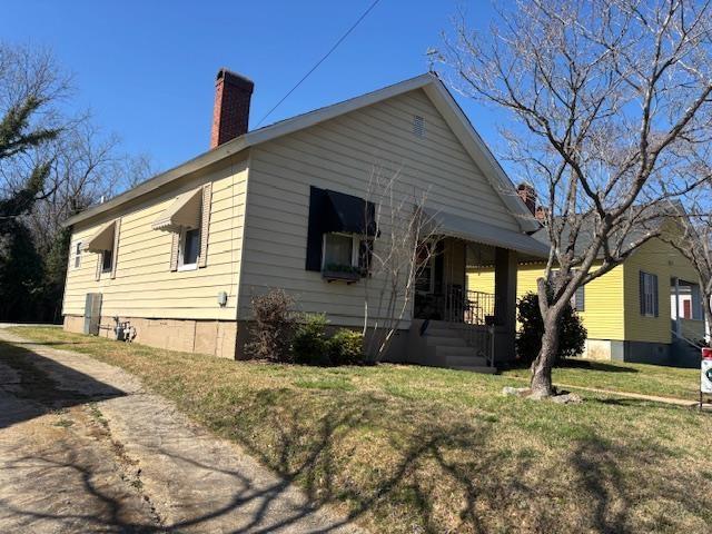 exterior space featuring a front yard and a chimney