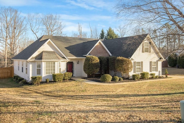 view of front of home featuring a front yard and fence