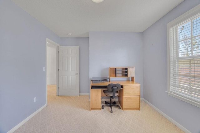 office with light colored carpet and baseboards