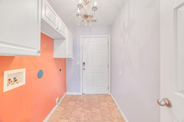 doorway to outside featuring a notable chandelier, visible vents, and baseboards