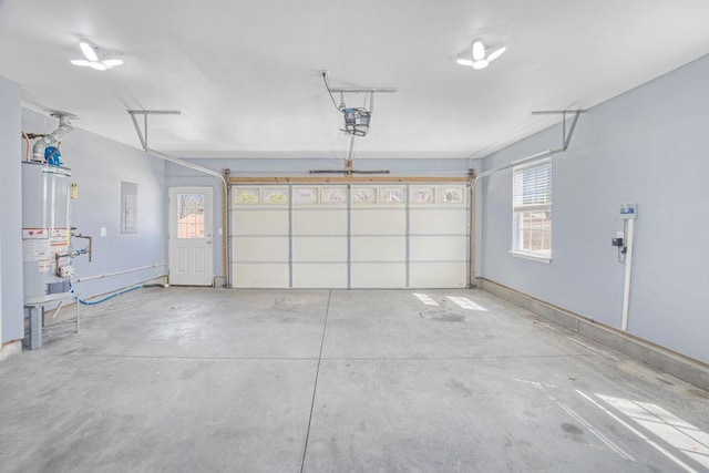 garage featuring gas water heater, electric panel, and a garage door opener