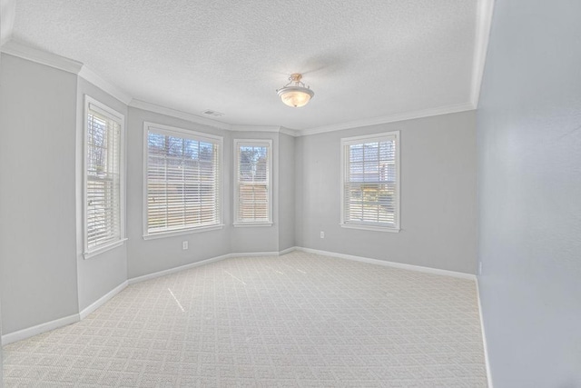 empty room with baseboards, light colored carpet, crown molding, and a textured ceiling