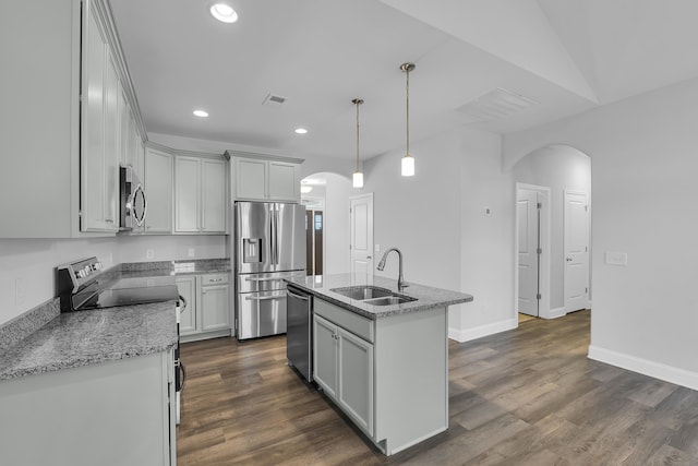 kitchen featuring dark wood finished floors, recessed lighting, appliances with stainless steel finishes, arched walkways, and a sink