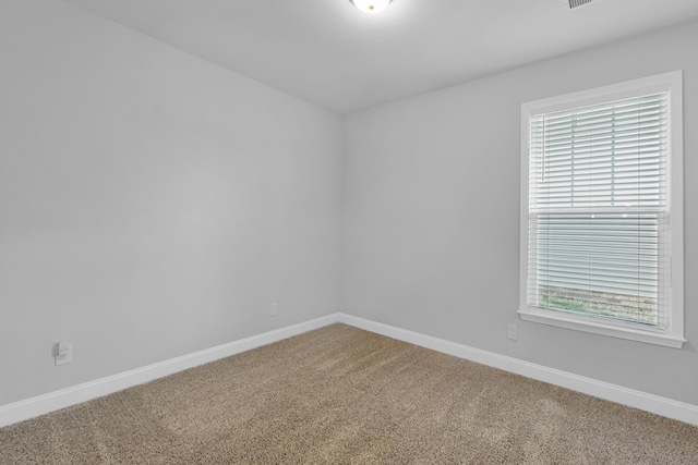 carpeted spare room with baseboards