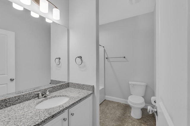 full bathroom featuring toilet, vanity, baseboards, and washtub / shower combination