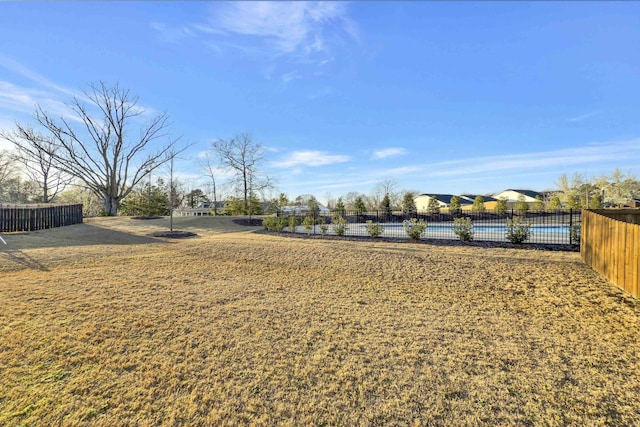 view of yard featuring a pool and fence