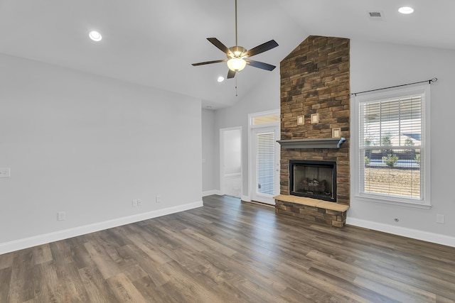 unfurnished living room featuring a stone fireplace, a ceiling fan, baseboards, and wood finished floors