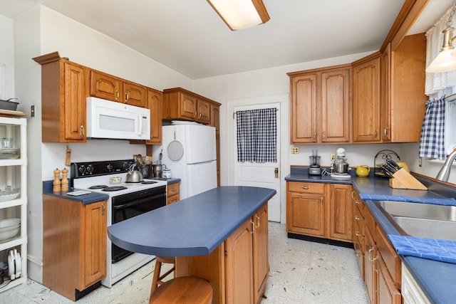 kitchen with a sink, white appliances, light floors, and dark countertops