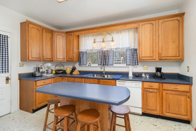 kitchen featuring light floors, white dishwasher, a sink, dark countertops, and a kitchen breakfast bar