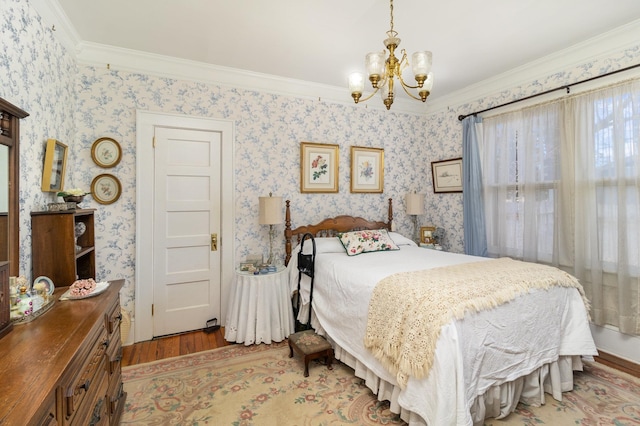 bedroom with an inviting chandelier, wood finished floors, and wallpapered walls