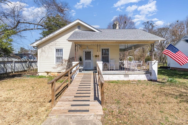 bungalow-style house featuring a front lawn, fence, roof with shingles, crawl space, and a chimney