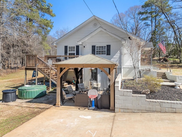 exterior space with stairs, a gazebo, and a wooden deck