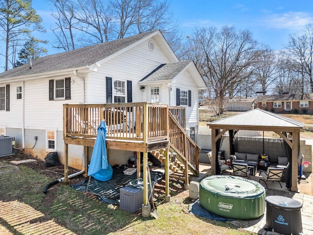 back of house featuring fence, roof with shingles, a wooden deck, a gazebo, and outdoor lounge area