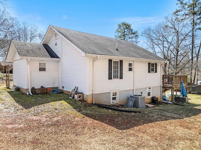 back of house with a wooden deck, central AC, and a shingled roof