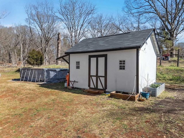 view of shed featuring a vegetable garden and an outdoor pool