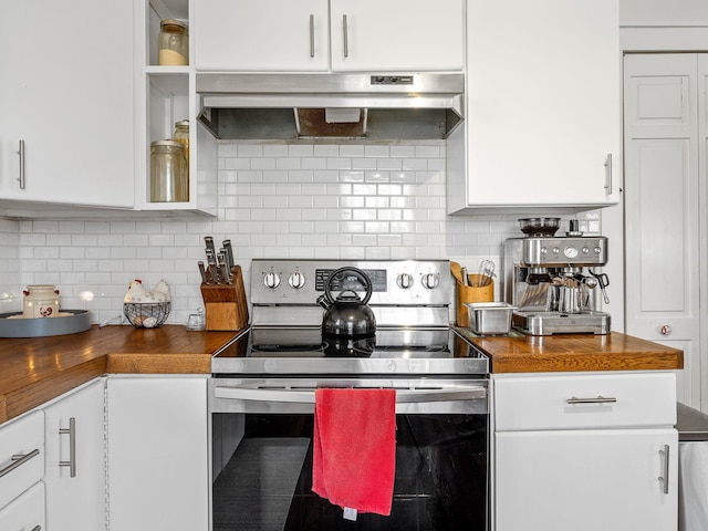 kitchen featuring under cabinet range hood, electric range, tasteful backsplash, and white cabinetry