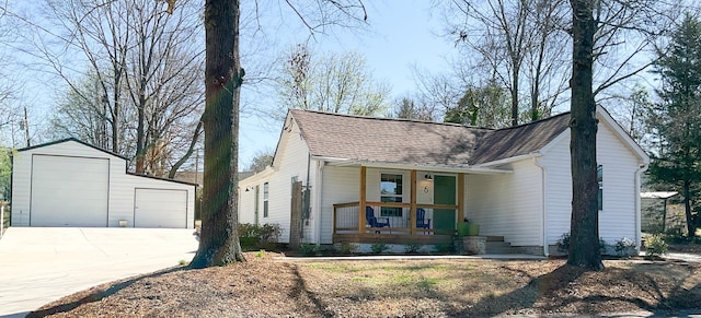 view of front facade featuring a porch, a garage, an outdoor structure, and roof with shingles