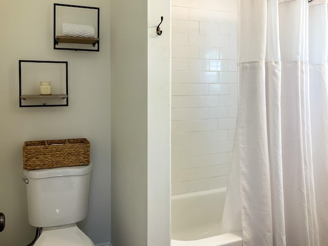 full bathroom featuring shower / bath combination with curtain and toilet