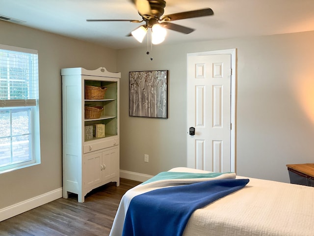 bedroom featuring visible vents, dark wood-style floors, baseboards, and ceiling fan