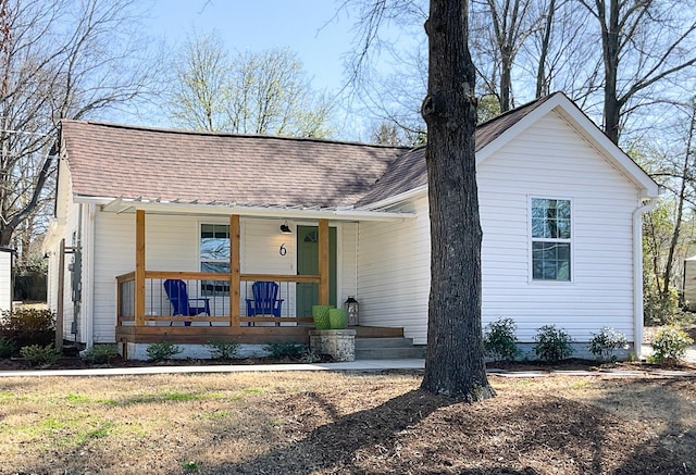 view of front of home with roof with shingles and a porch