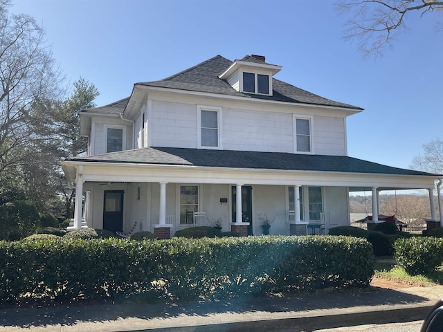 view of front of property featuring covered porch and roof with shingles