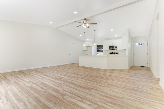 unfurnished living room featuring light wood-style flooring, vaulted ceiling with beams, baseboards, and ceiling fan