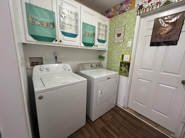 clothes washing area with wallpapered walls, dark wood-type flooring, baseboards, washer and dryer, and cabinet space