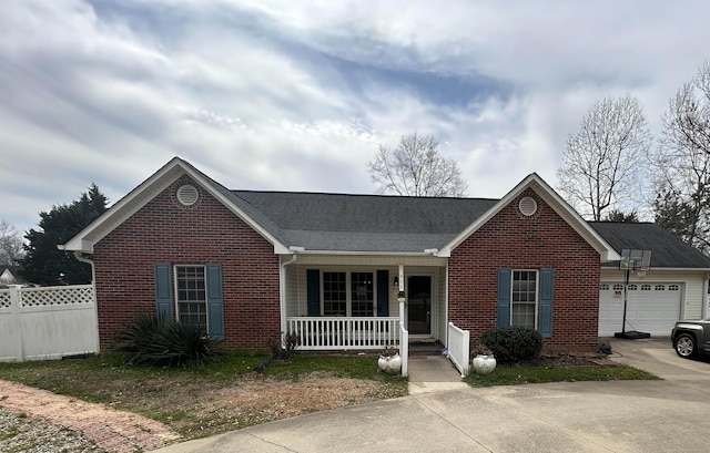 single story home featuring brick siding, fence, covered porch, and driveway