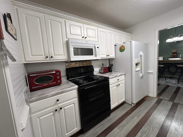 kitchen with dark wood-type flooring, white appliances, white cabinetry, and light countertops