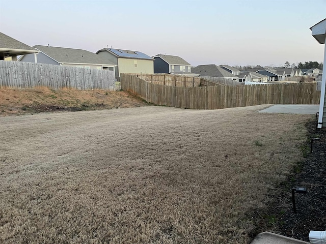 view of yard featuring a residential view and fence