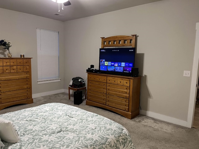 bedroom with visible vents, baseboards, carpet, and ceiling fan