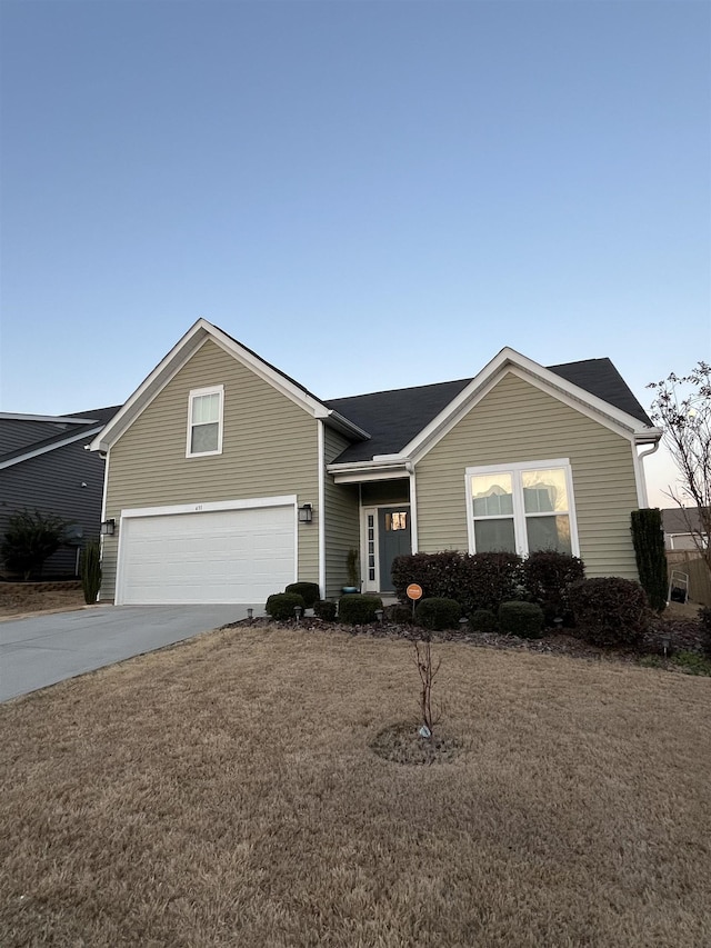 single story home with concrete driveway and a garage