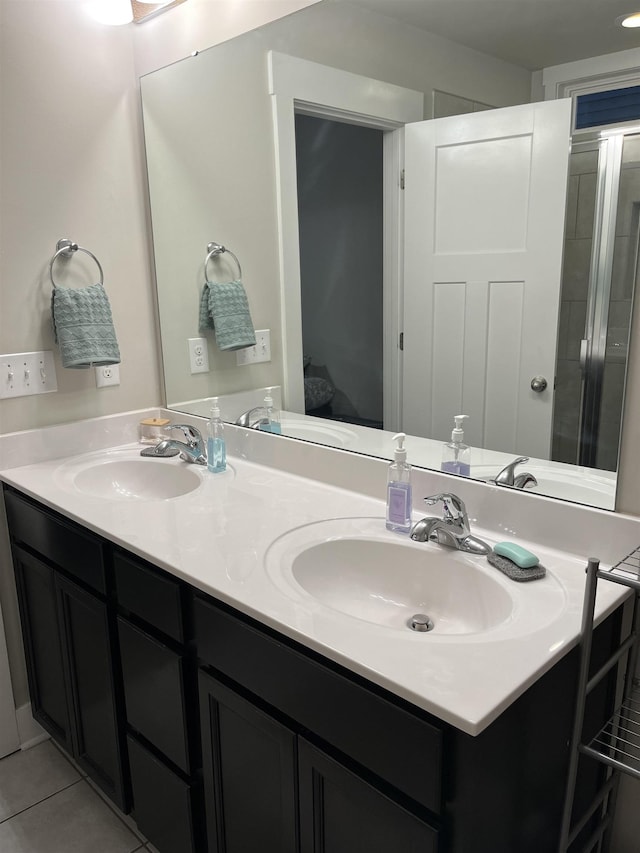 full bathroom featuring a sink, double vanity, and tile patterned floors