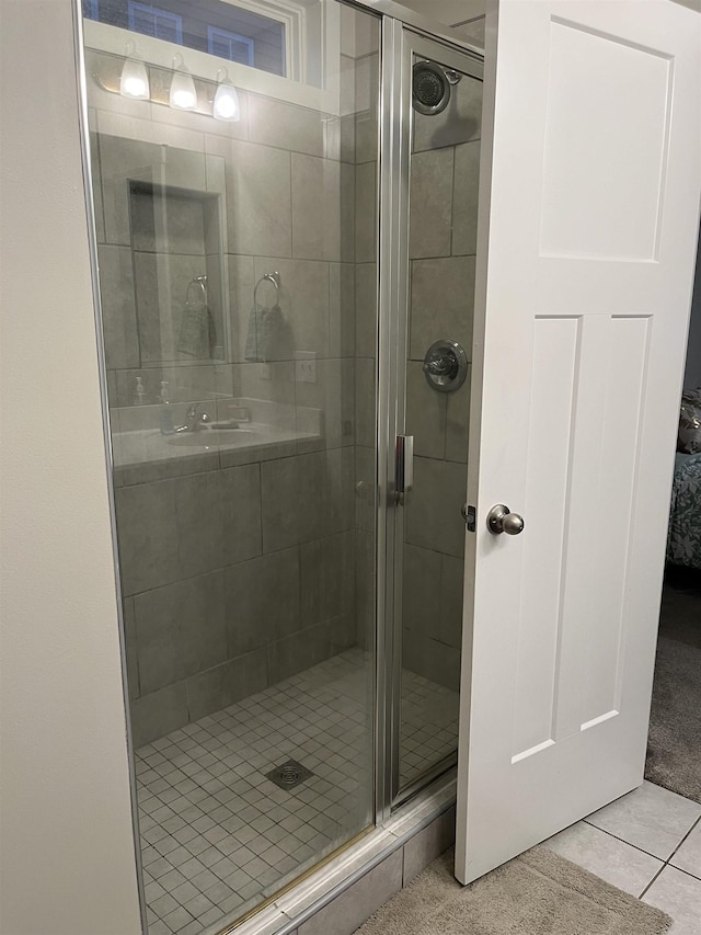 bathroom featuring tile patterned floors and a shower stall