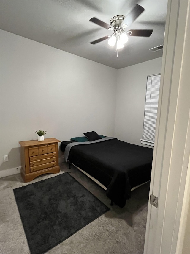 bedroom with visible vents, carpet floors, and a ceiling fan