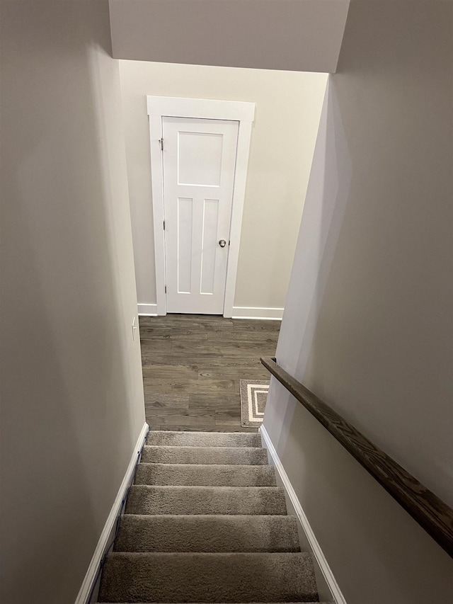 stairs with visible vents, baseboards, and wood finished floors