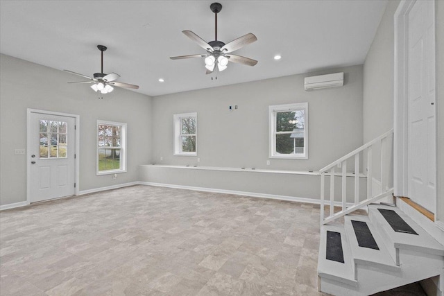 unfurnished living room featuring an AC wall unit, recessed lighting, baseboards, ceiling fan, and stairs