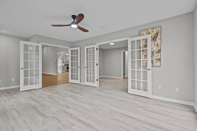 spare room with french doors, baseboards, and wood finished floors