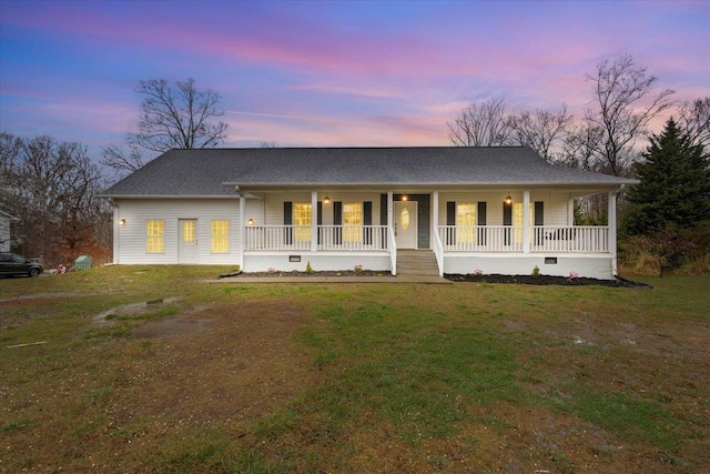 view of front facade featuring a porch, a lawn, and crawl space