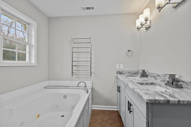 full bath with visible vents, a sink, a textured ceiling, a jetted tub, and radiator