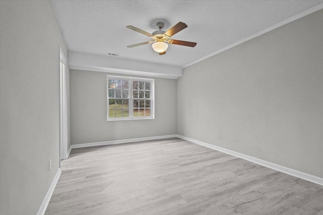 unfurnished room with visible vents, a textured ceiling, wood finished floors, baseboards, and ceiling fan