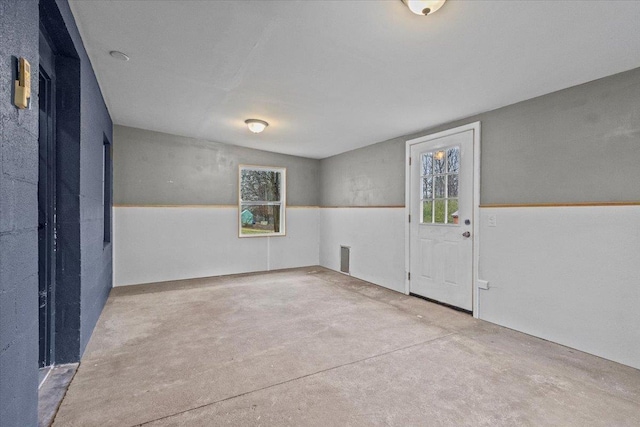 interior space featuring a wealth of natural light, visible vents, and concrete floors